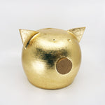 Elegant golden piggy bank with intricate detailing, perfect for home decor and savings inspiration.